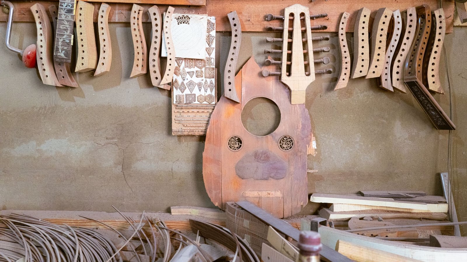 Wide shot of a serene musical instrument workshop in Fukuoka, with natural light illuminating the workbenches.